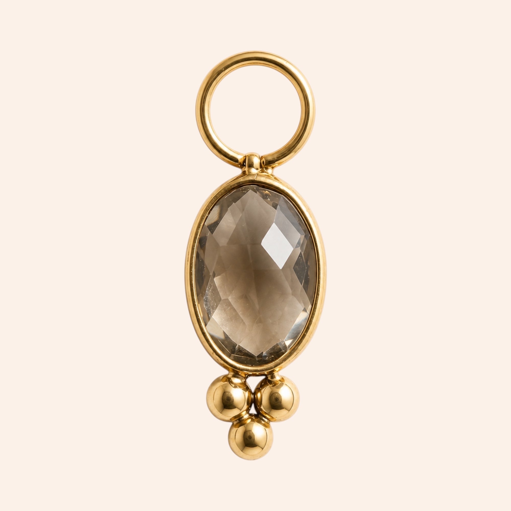 Ma boutique Ambre interchangeable earring charm with an oval amber-toned stone and gold stainless steel accents.