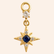 Ma boutique Astre gold star earring charm featuring a central blue stone and clear crystal accents in stainless steel