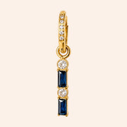 Ma boutique Emeraude interchangeable earring charm with gold-tone stainless steel, blue baguette stones, and crystals.