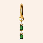 Ma boutique Emeraude interchangeable earring charm with green and clear stones on a gold stainless steel setting.