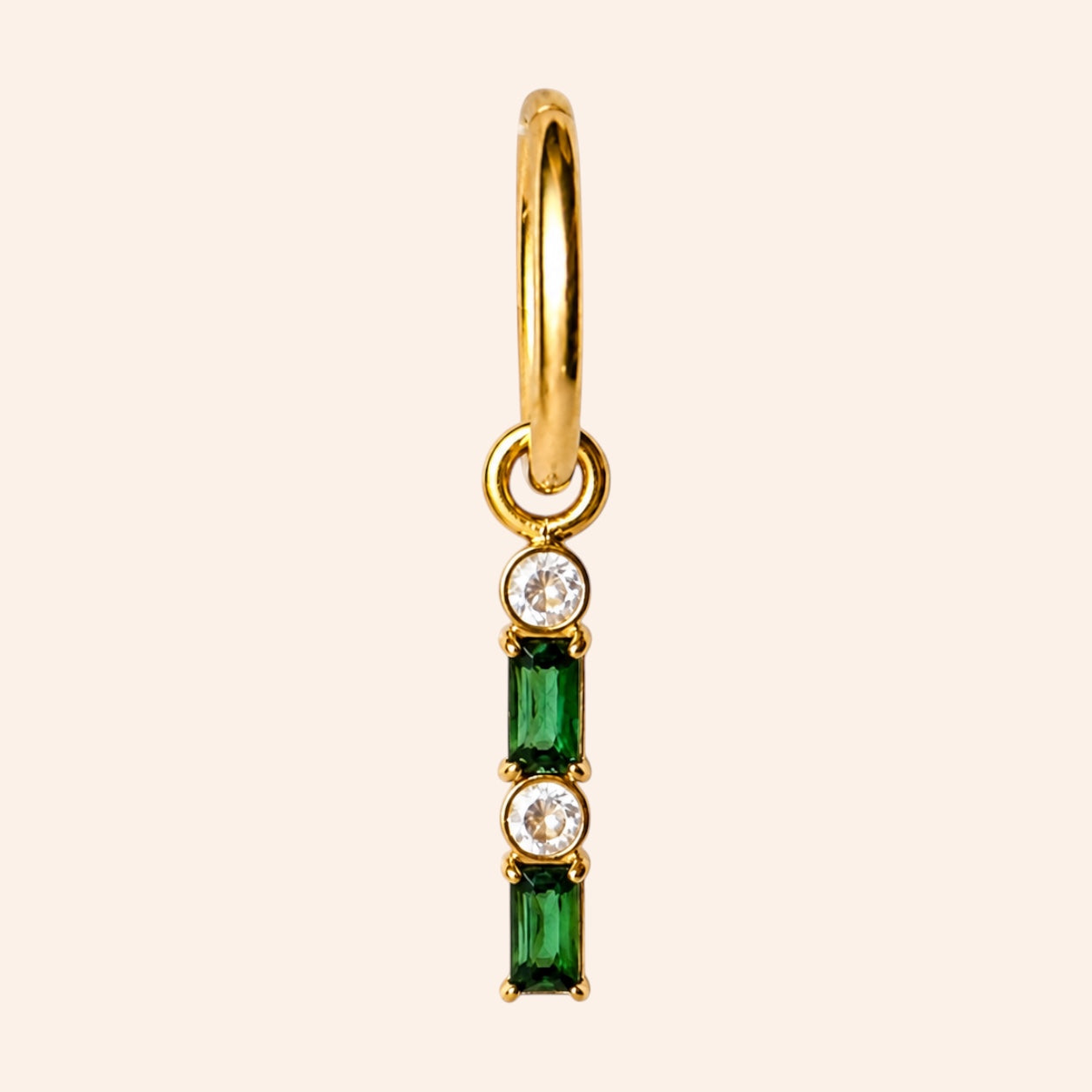 Ma boutique Emeraude interchangeable earring charm with green and clear stones on a gold stainless steel setting.