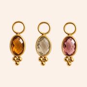 Ma boutique Ambre interchangeable earring charms featuring oval amber, clear, and pink stones set in gold stainless steel