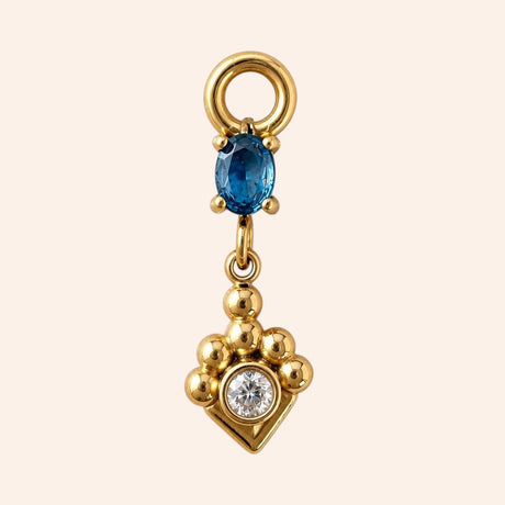 Ma boutique Joyau interchangeable earring charm in gold stainless steel with a blue oval stone and clear crystal.