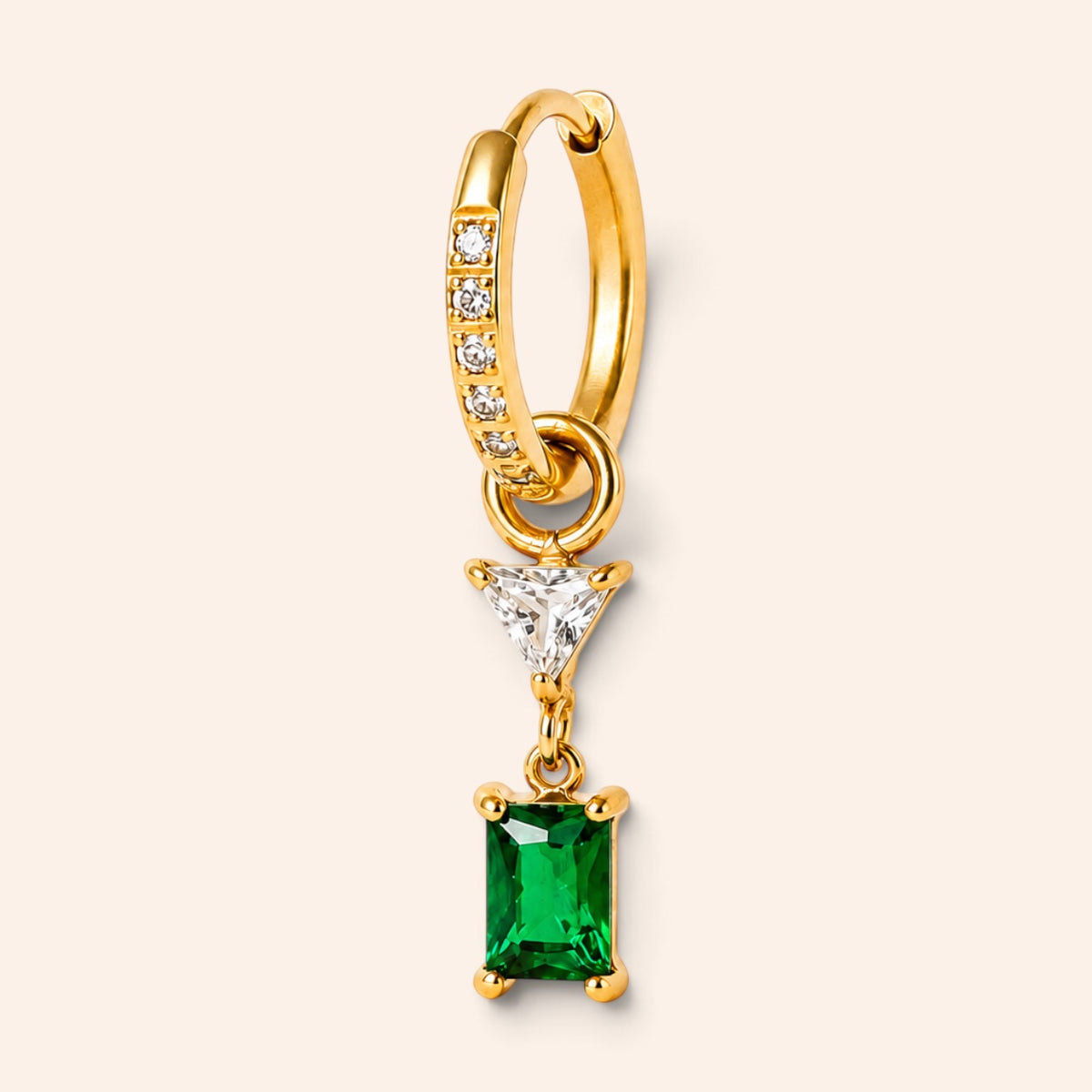 Ma boutique Minuit gold hoop earring with a dangling emerald green rectangular stone and a small clear triangle charm.