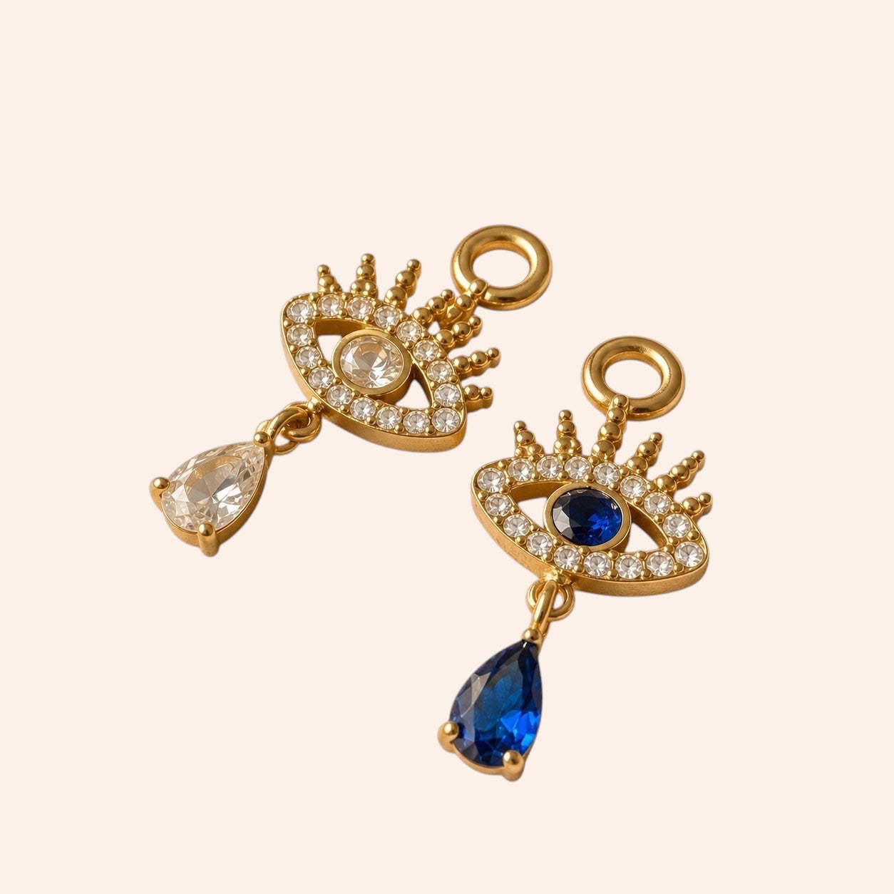Ma boutique Nazar interchangeable gold earring charms featuring blue and clear crystal eye motifs with teardrop drops.
