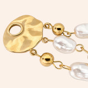Ma boutique Néréide interchangeable earring charm with gold-toned hammered metal and white pearlescent beads