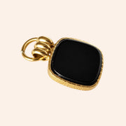 Ma boutique Nox interchangeable earring charm with a black onyx square pendant and gold-toned textured border