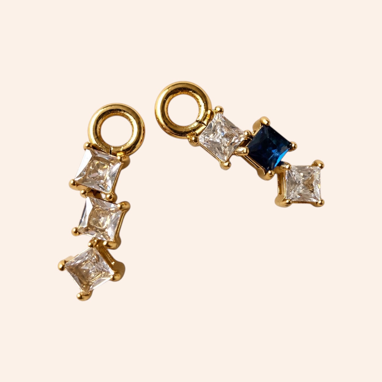 Ma boutique Prisme interchangeable earring charms with square-cut clear and blue stones set in gold stainless steel.