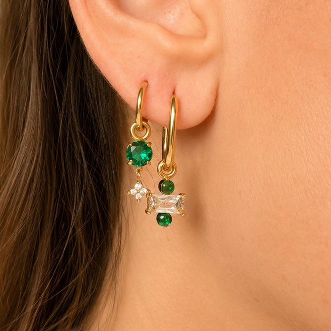 Ma boutique Regard interchangeable gold earring charm with green and clear crystals worn on a hoop earring