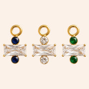 Ma boutique Regard interchangeable earring charms in gold stainless steel with blue, clear, and green crystal accents.