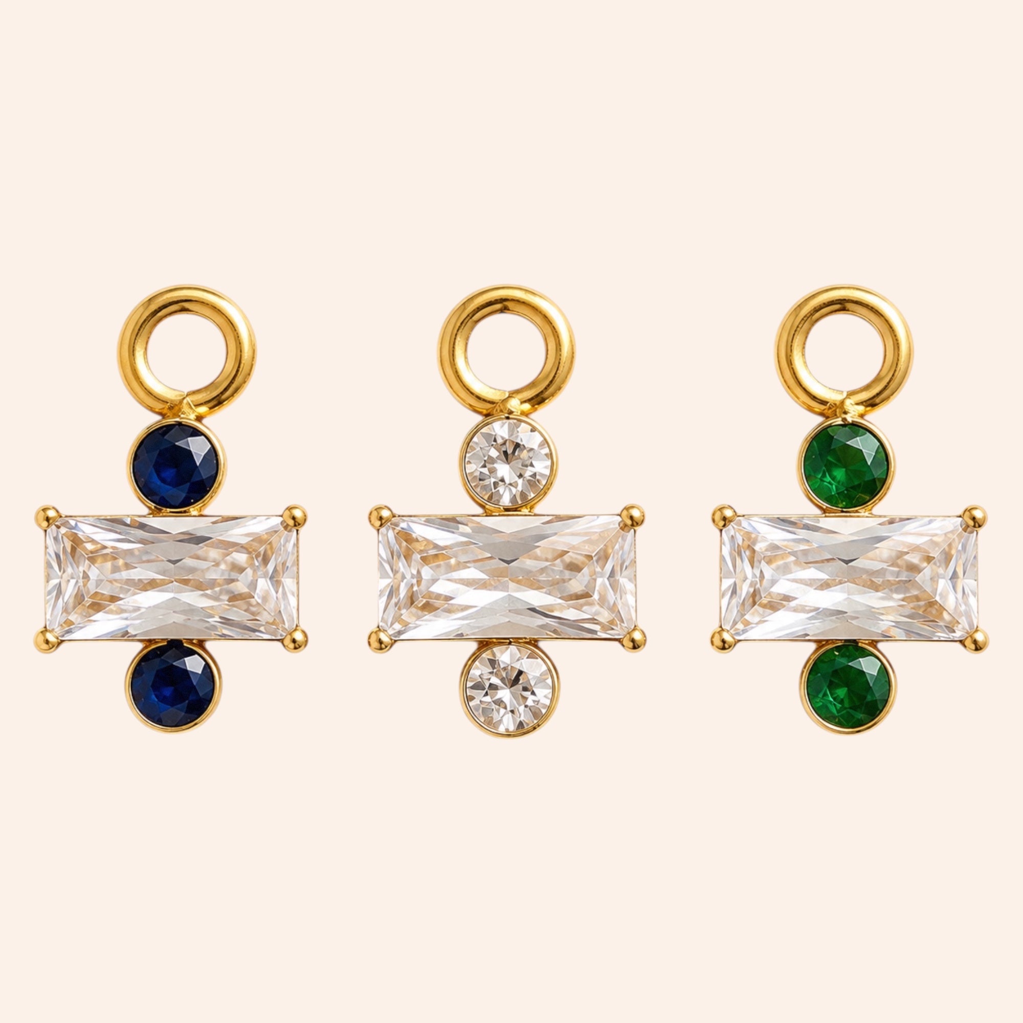 Ma boutique Regard interchangeable earring charms in gold stainless steel with blue, clear, and green crystal accents.